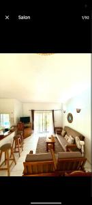 a living room with a couch and a table at Elysee in Mbour +44 photos