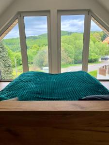 a bed in a room with a large window at Altitude 2 Matra in Mátraszentimre +9 photos