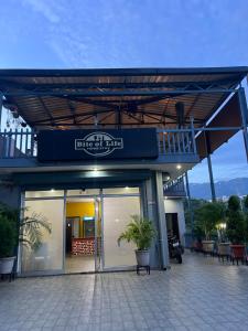 a building with a sign on the side of it at Bite of Life Cafe and Resort in Dehradun