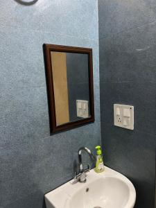a bathroom with a sink and a mirror at Bite of Life Cafe and Resort in Dehradun +52 photos