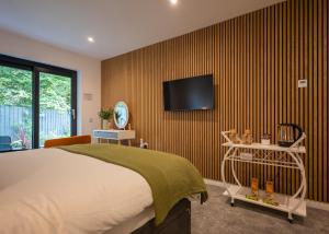 a bedroom with a bed and a tv on a wall at Beechwood in Oban