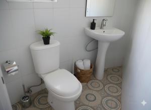 a bathroom with a toilet and a sink at Otogo Guest House in Gulu