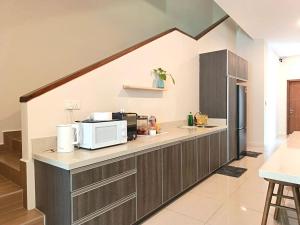 a kitchen with a counter top with a microwave at Mutiara Gurney at 15, Lorong Kelawai in George Town