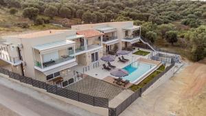 an aerial view of a house with a swimming pool at Aura Luxury Home in Pogoniá
