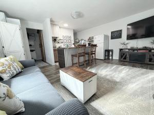 a living room with a couch and a kitchen at Finally Home Guesthouse in Burns