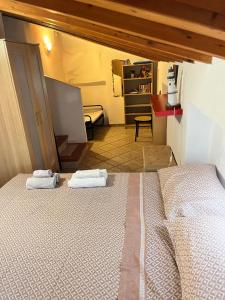 a bedroom with two beds in a room at Casa Vacanze - Maison des Poupées in Maranola