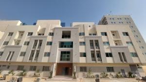 a large white building with trees in front of it at شقة راقية وفاخرة in Riyadh