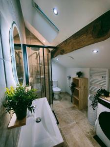 a bathroom with a tub and a toilet and a sink at Maisonnette de prestige au cœur des vignes in Couchey