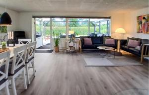 a living room with a couch and a table at Nice Home In Tarm With Kitchen in Hemmet