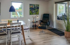 a living room with a table and chairs and a desk at Nice Home In Tarm With Kitchen in Hemmet