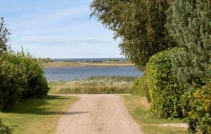 a dirt road next to a body of water at Amazing Home In Føllenslev With Wifi in Føllenslev +25 photos