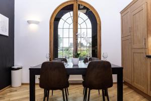 a dining room with a table and chairs and a window at The Chapel - Telford in Telford