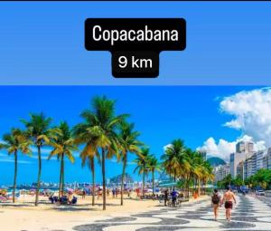 a beach in cuba with palm trees and buildings at Apartamento completo e moderno com ar condicionado e piscina no centro do RIO in Rio de Janeiro