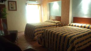Postel nebo postele na pokoji v ubytování Hotel La Rienda Mision Tequillan