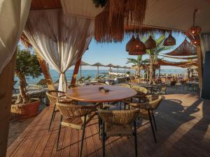 a patio with a table and chairs and the ocean at Villa Maria in Balchik