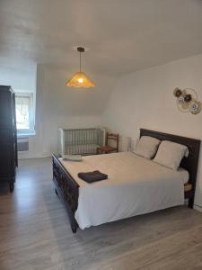 a bedroom with a large bed and a light at Maison de vacances in Plémy
