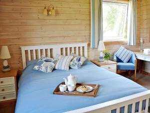 a bed in a room with a tray on it at Hawthorne in Woolfardisworthy