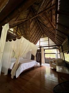 a bedroom with a bed with a mosquito net at Lodges Boutique La Nuit in La Vega