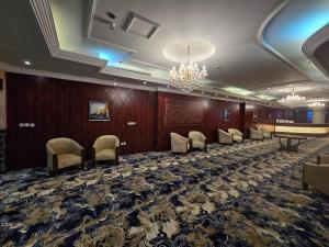 a large room with chairs and a chandelier at Maysan AL Multaqa Hotel in Al Masfalah