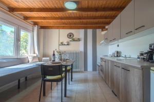 a kitchen with a table and some chairs in a room at Step Inn Kastoria in Kastoria