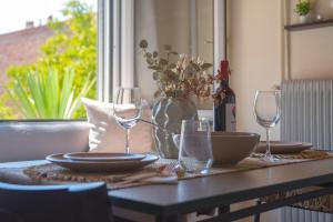 a table with two wine glasses and a bowl on it at Step Inn Kastoria in Kastoria