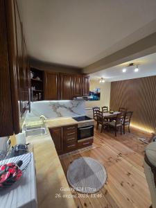 a kitchen and a dining room with a table at Vila ALDIMARA in Žabljak