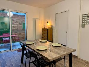 a dining room with a wooden table and chairs at Maison de Campagne de Charme à Bellevigny in Saligny
