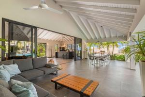 a living room with a couch and a table at Stylish 3 Bedroom Villa With Ocean Views And Daily Maid Service in Willemstad