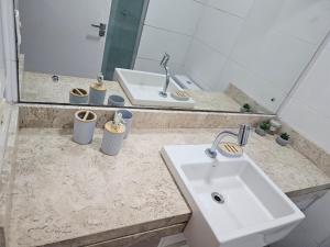 a bathroom with a sink and a mirror at Apt conforto e aconchegante prox a Novafapi e ao Shopping Carnauba in Teresina +18 photos