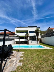a villa with a swimming pool and a house at Villa Vincek in Mostar