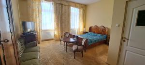 a bedroom with a bed and a table and a chair at Hotel i Restauracja Chopin in Żary