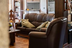 a brown leather couch in a living room at Casa de Trillo Galitrips in Rego de Santa Marina
