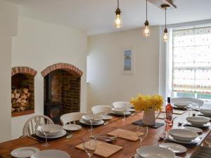 a dining room with a long wooden table and chairs at West House Farm in Filey