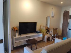 a living room with a flat screen tv on a wall at The Shore KK - Seaview Suite with Stunning Sunset & Private Balcony in City Centre in Kota Kinabalu