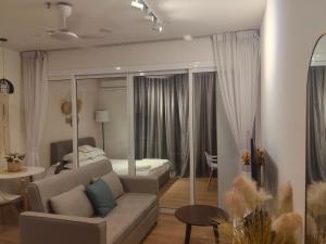 a living room with a couch and a bed at The Shore KK - Seaview Suite with Stunning Sunset & Private Balcony in City Centre in Kota Kinabalu +15 photos