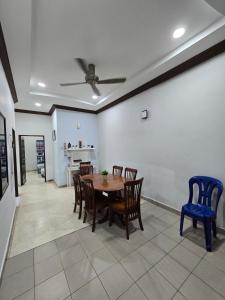 a dining room with a table and chairs at PD Shell Gate Home Stay in Port Dickson