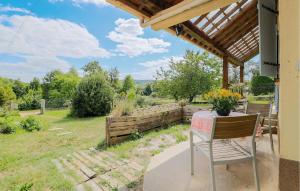 a table and a chair on a porch with a view at Jolie Maison Proche Rivière in Jaulgonne
