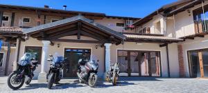 three motorcycles parked in front of a building at Antica Fontana in Bernezzo