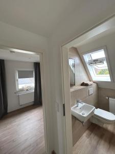 a bathroom with a sink and a mirror at Ferienhaus Zingel in Eckernförde +35 photos