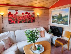 a living room with a couch and a table at Retreat Øklandsnes in Tjernagel