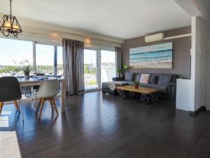 a living room with a couch and a table at Atalaya Apartment by Hello Homes Sitges in Sitges +17 photos