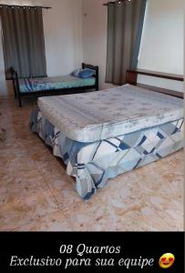 two beds in a room with avisorrativerative panel slab furniture at ChacaraSophya in Aquiraz