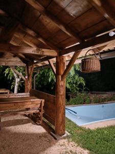 a wooden pergola with a bench and a tub at Bujtina Selimaj in Plav