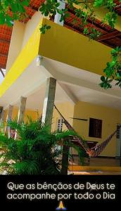 a person on a hammock in a building at ChacaraSophya in Aquiraz +15 photos