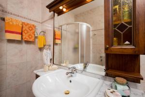 a bathroom with a sink and a mirror at Apartment Dolores in Opatija +5 photos