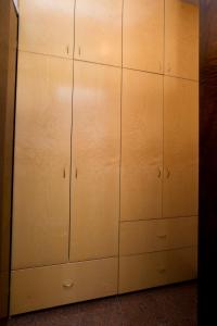 a closet with white cabinets and a wall at Apartment Dolores in Opatija