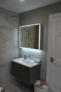 a bathroom with a sink and a mirror at The Fairways, CastleBlayney in Castleblayney