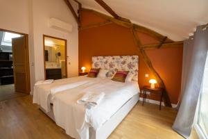 a bedroom with a large bed in a room at Domaine Chapelle in La Chapelle-la-Reine +91 photos
