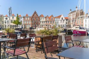 a group of tables and chairs at a marina at Hotel De Grote Kade - Boutique Heritage Hotel in het historische hart van Goes in Goes