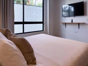 a bedroom with a bed and a large window at Villa Milá in Salento